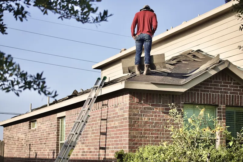 Professional roofer working on a residential roof in Brown Farm
